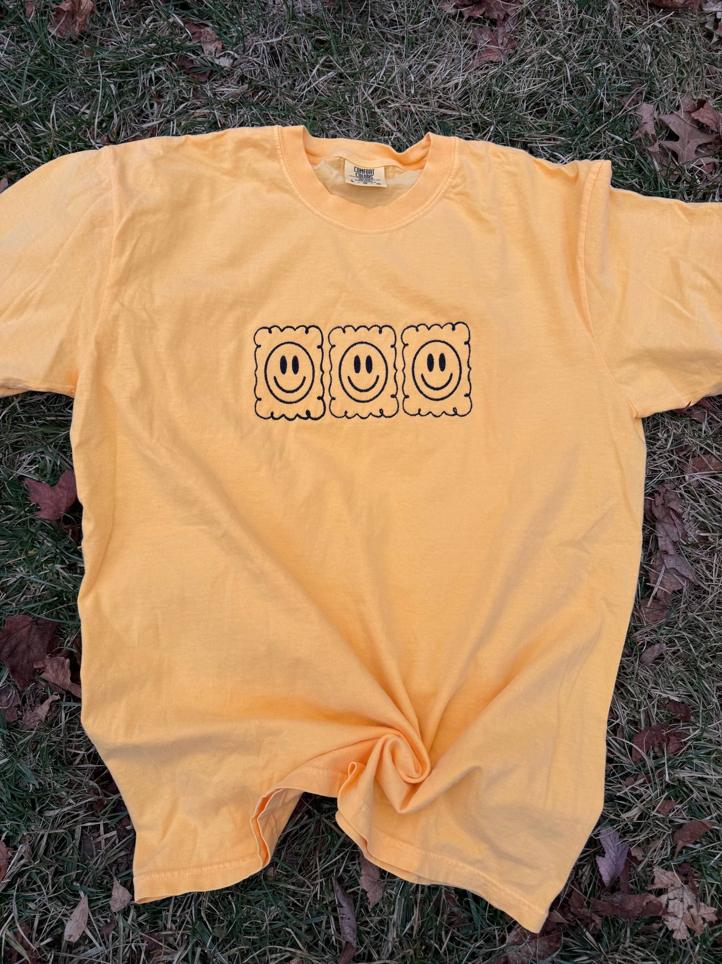 Smiley face embroidered tshirt. 